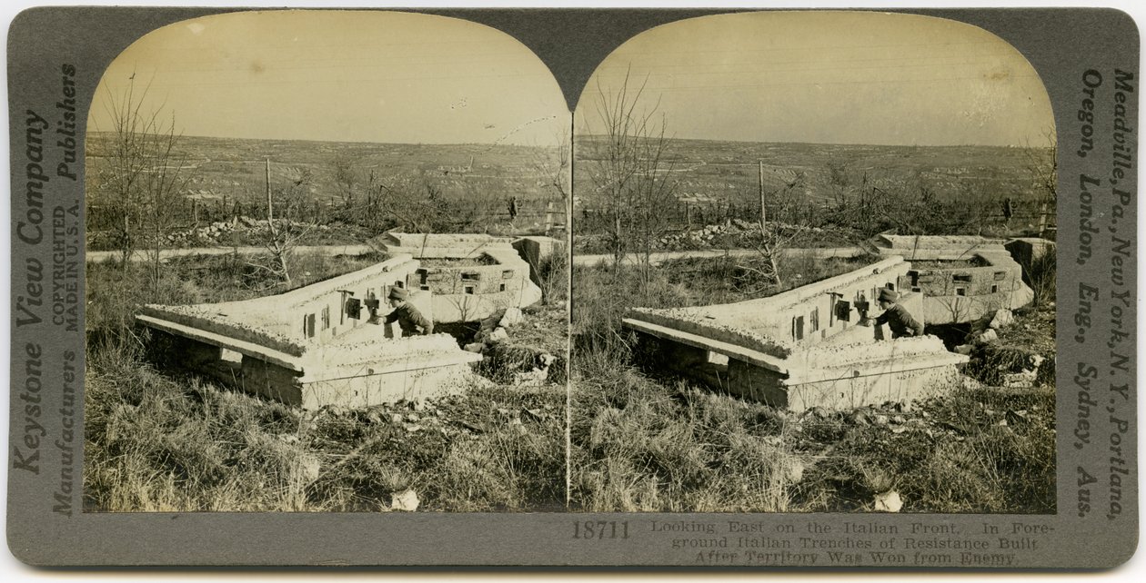 Horisontellt sepia -stereokort som visar en uniformerad man som står bakom en uppsättning betongrövar i ett öppet fält. Keystone -stereografnummer 18711. Titeln lyder av Keystone View Company
