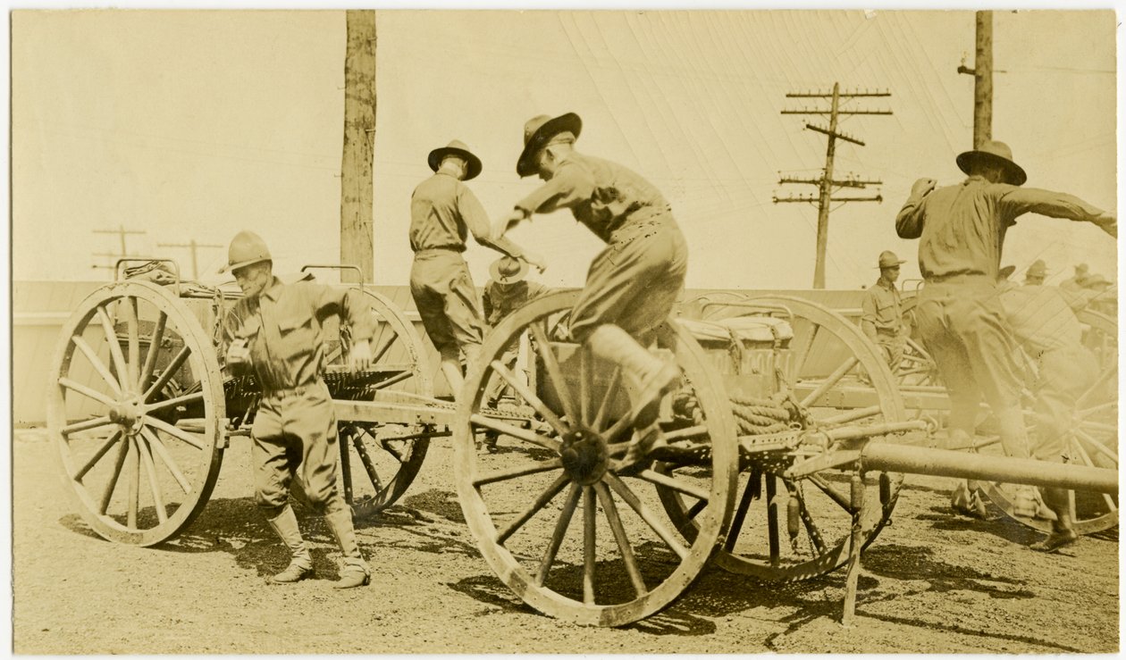 Horizontal, sepia photograph showing uniformed men in the process of jumping down from an open cart bearing supplies. Towers of power lines can be seen in the background av Carl Michel