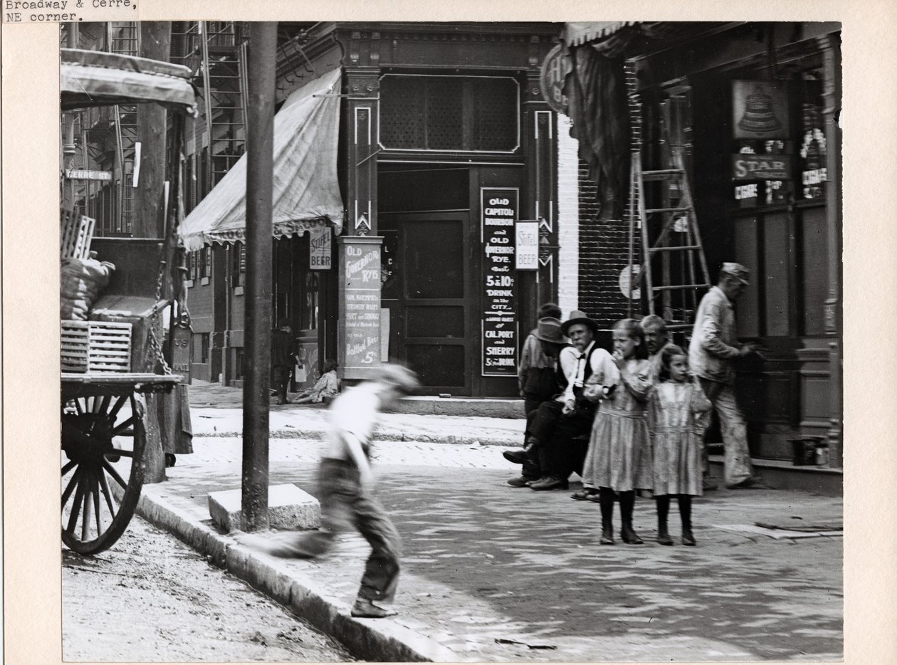A boy runs onto the sidewalk near two girls at the corner of Broadway and Cerre av Charles Clement Holt