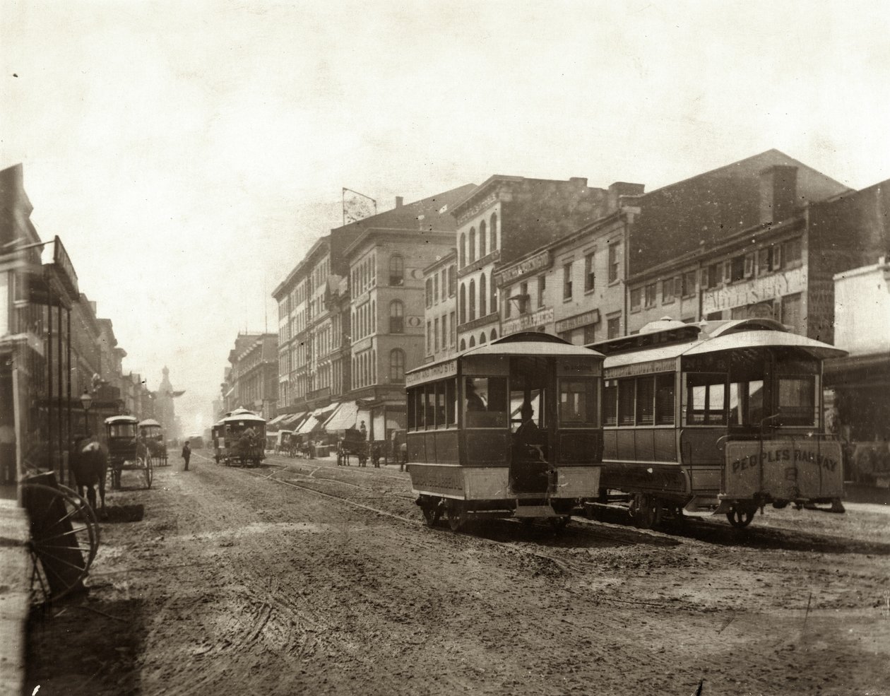 View of streetcars traveling on Fourth Street south of Morgan Street. Morgan Street was also known as Delmar Boulevard, and later as Convention Plaza av Emil Boehl
