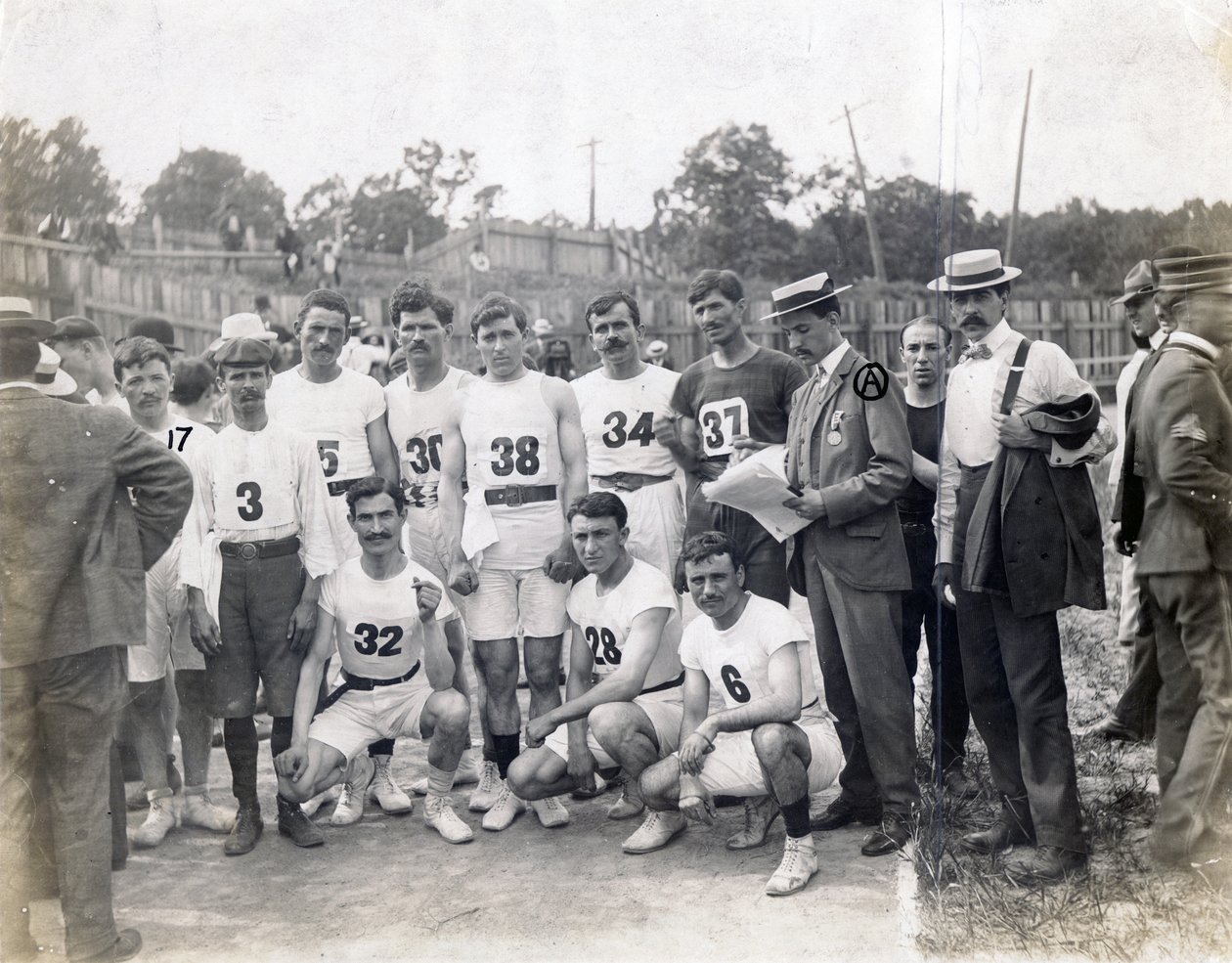 Group of Greek Athletics and Felix Carbejaldesoto of Cuba posing on track including av Jessie Tarbox Beals