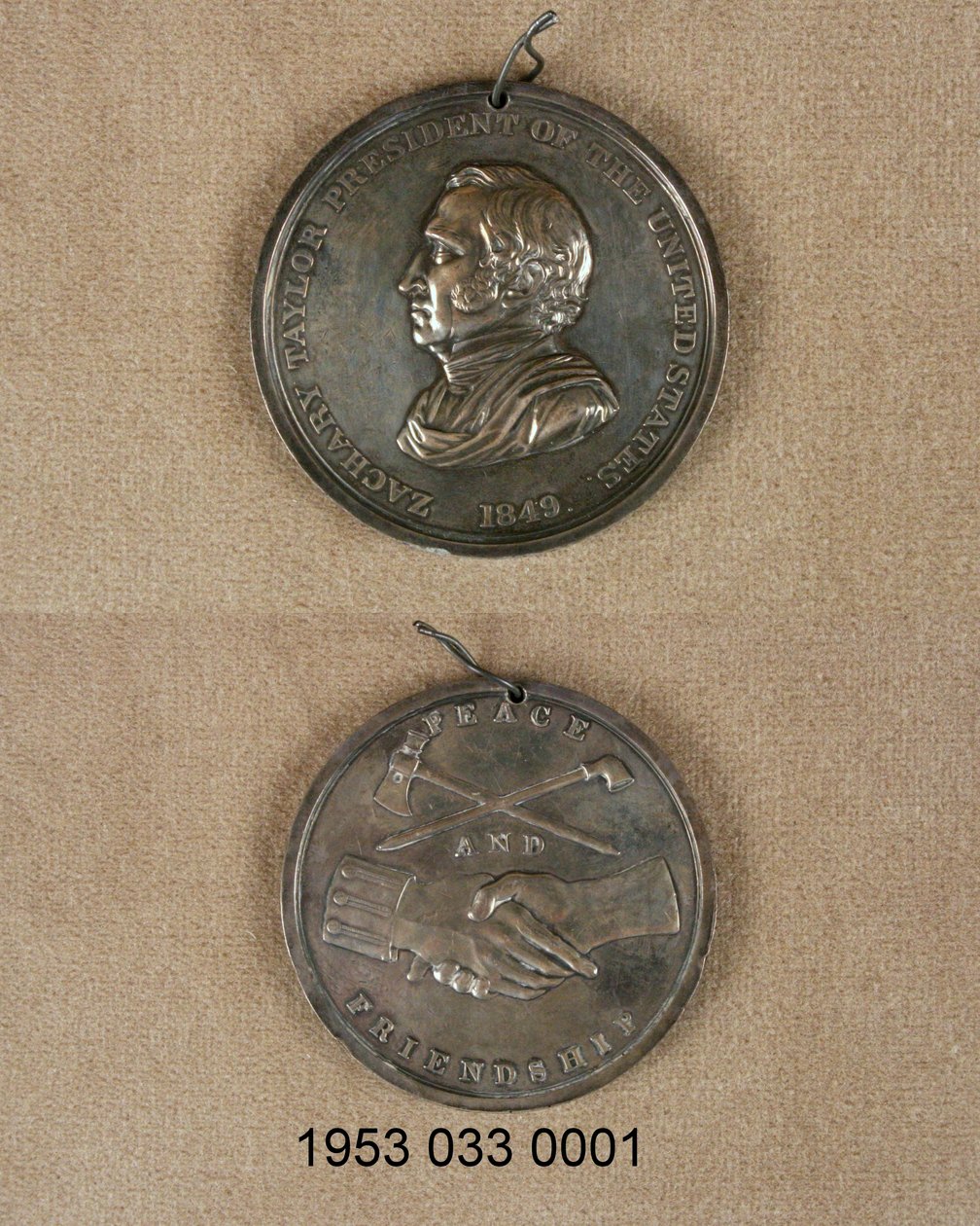 Silver peace medal/obverse has bust of Zachary Taylor/reverse has crossed pipe and hatchet above clasped hands, one with uniform cuff av Unknown
